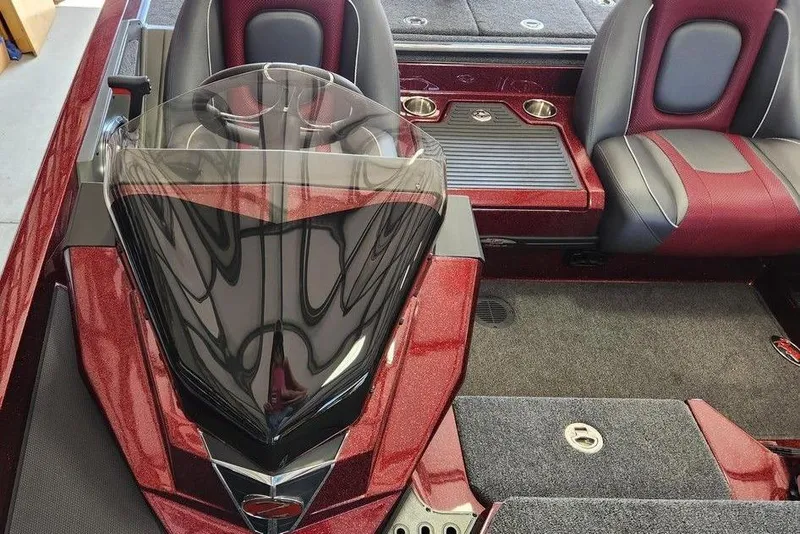 Slide: The Image of 2026 Ranger Z518 Cup-Equipped boat interior with red and black seating in a garage. - 10