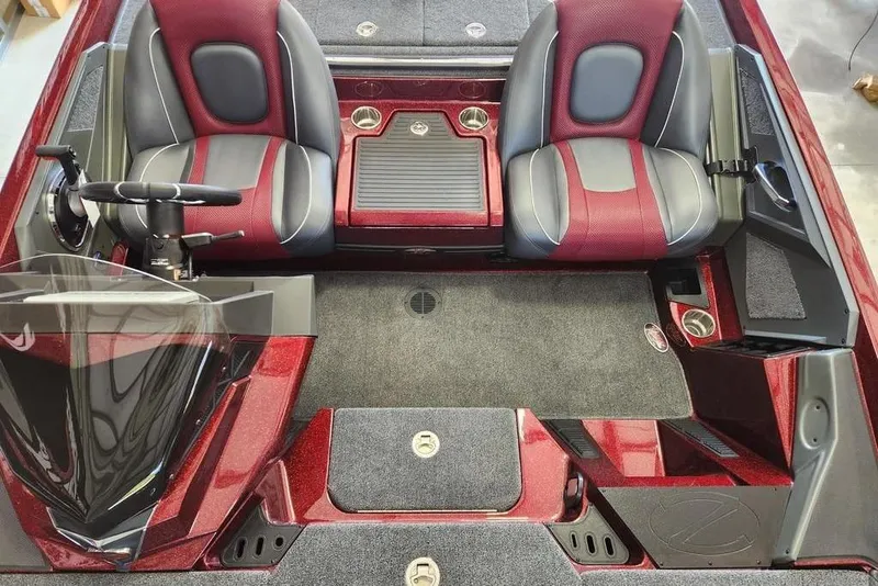 Slide: The Image of 2026 Ranger Z518 Cup-Equipped boat interior with red and gray seating in a garage setting. - 12