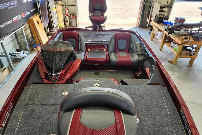 Slide: The Image of 2026 Ranger Z518 Cup-Equipped boat dashboard with Garmin display and steering wheel. - 4