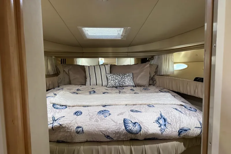 Slide: The Image of Luxurious cabin interior of 2000 Sea Ray 380 Sundancer yacht with cozy bedding. - 13