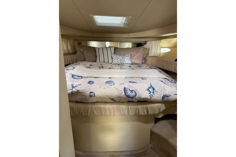 Slide: The Image of Cozy cabin interior of 2000 Sea Ray 380 Sundancer with nautical-themed bedding. - 14