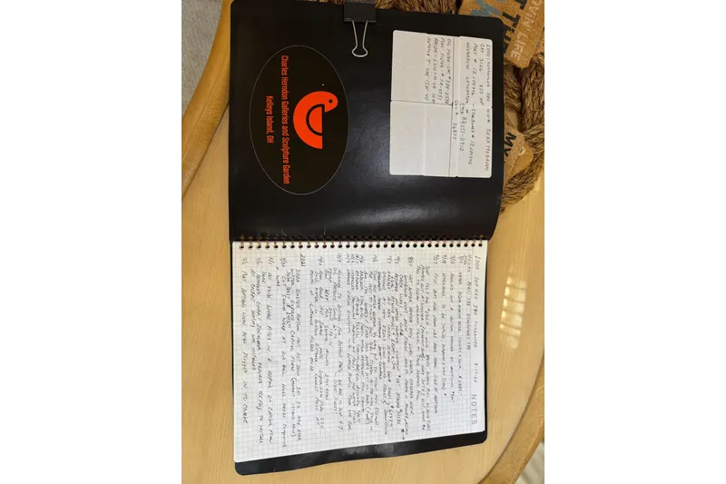 Slide: The Image of Open notebook with handwritten notes, Sea Ray 380 Sundancer 2000, on a wooden table. - 18