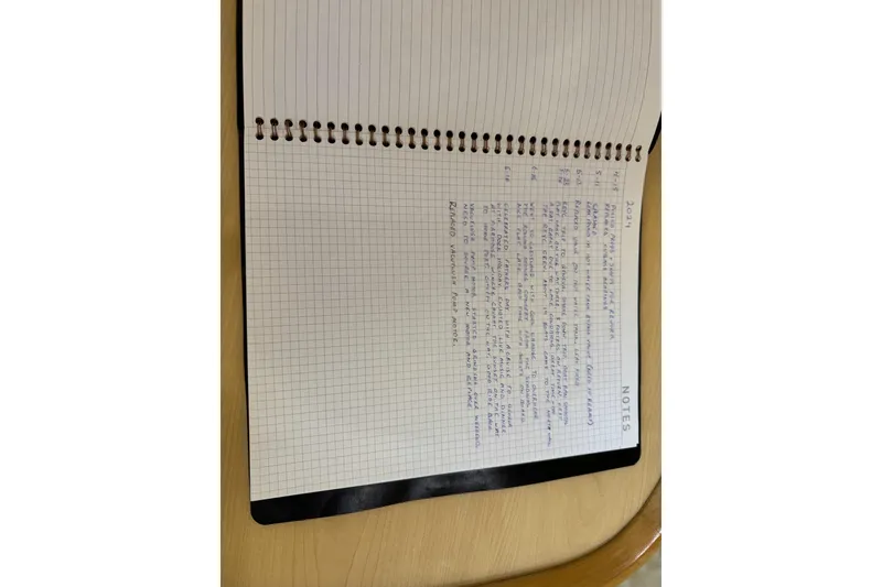 Slide: The Image of Open notebook with handwritten notes on a wooden table. - 19