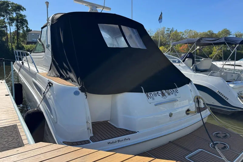 Slide: The Image of 2000 Sea Ray 380 Sundancer docked, featuring a black canvas cover and sleek design. - 3