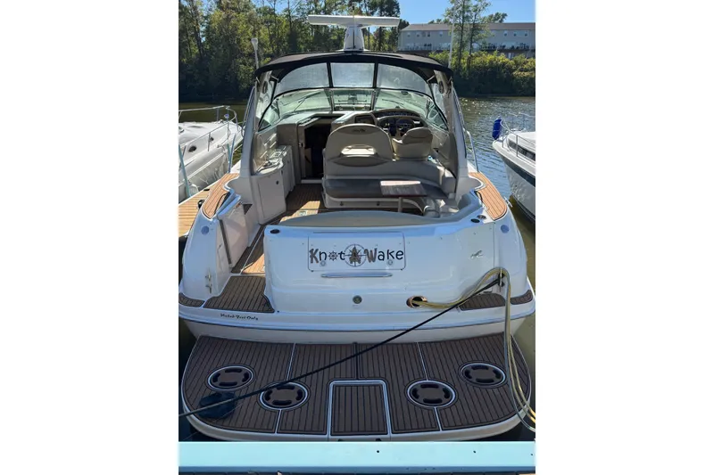 Slide: The Image of 2000 Sea Ray 380 Sundancer docked, rear view with open cockpit and seating. - 4