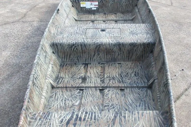 Slide: The Image of 2026 Tracker Grizzly 15 Jon boat with camouflage interior design on concrete surface. - 4