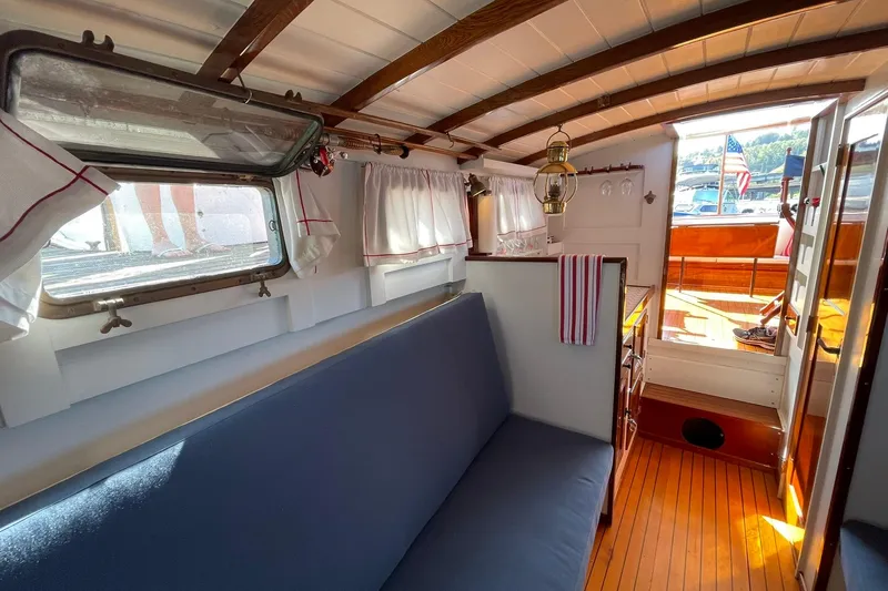 Slide: The Image of Interior of 1939 Richardson 26 Little Giant boat with wooden accents and cozy seating. - 16