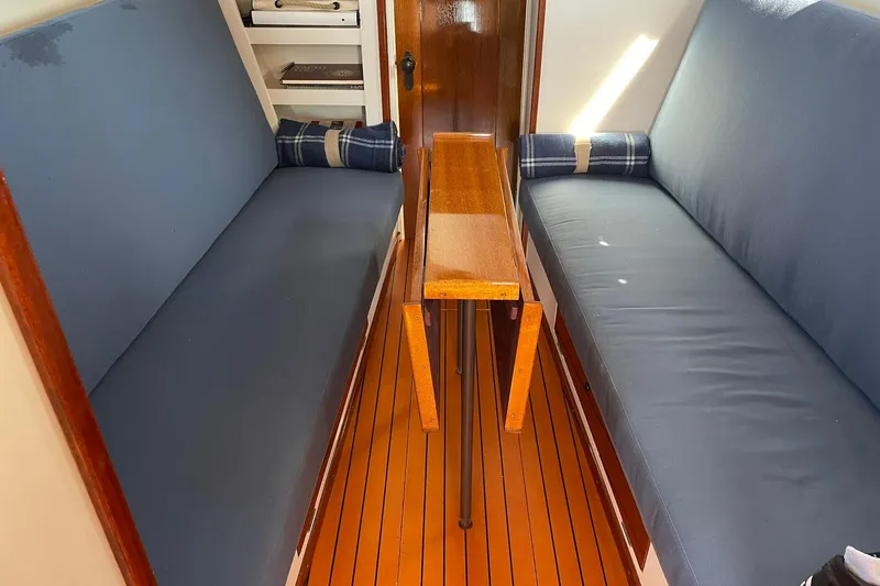 Slide: The Image of Interior of 1939 Richardson 26 Little Giant boat with blue seating and wooden table. - 22