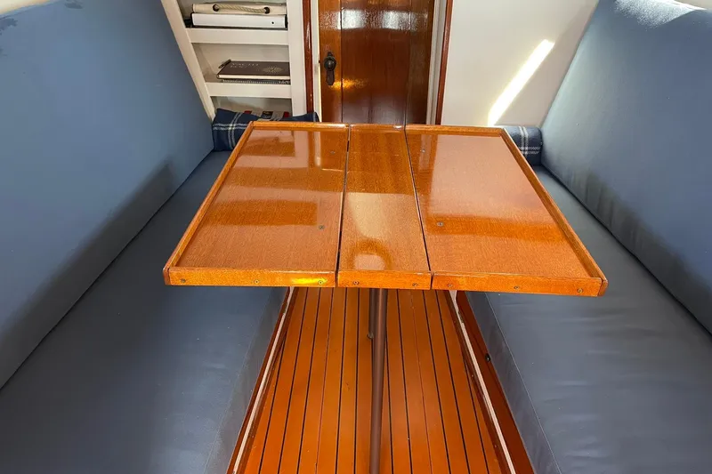Slide: The Image of Interior of 1939 Richardson 26 Little Giant boat with wooden table and blue seating. - 23