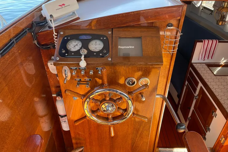 Slide: The Image of 1939 Richardson 26 Little Giant boat helm with vintage gauges and wooden steering wheel. - 26