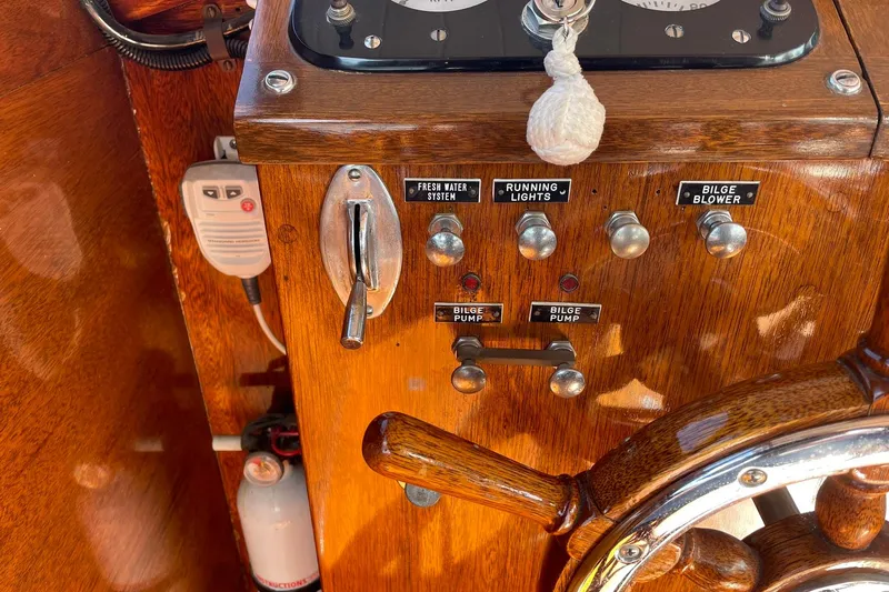 Slide: The Image of 1939 Richardson 26 Little Giant boat controls with switches and wooden steering wheel. - 28
