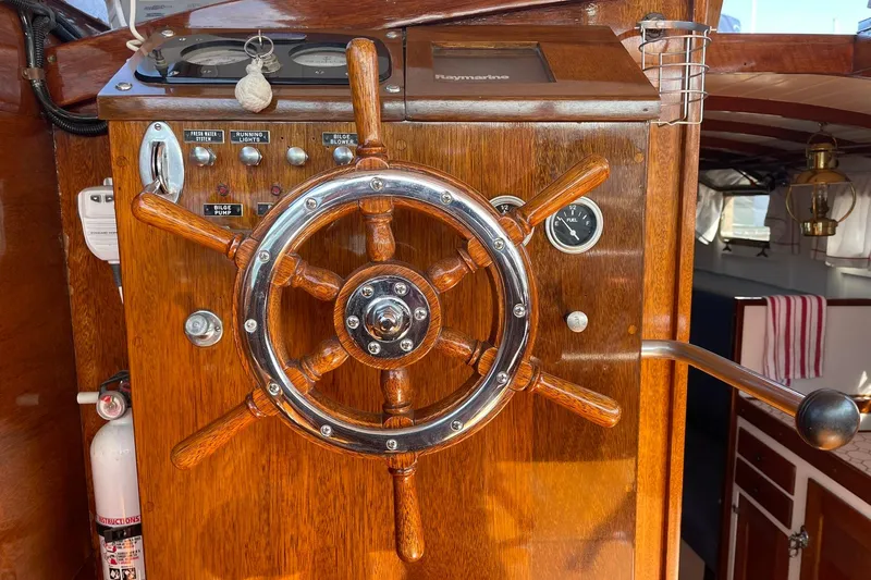 Slide: The Image of Wooden helm of 1939 Richardson 26 Little Giant boat with gauges and controls. - 30