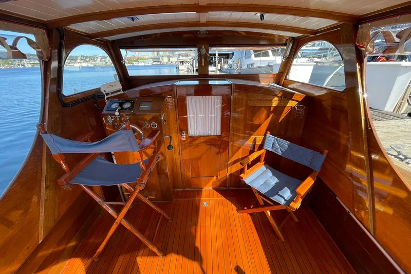 Slide: The Image of Interior of 1939 Richardson 26 Little Giant boat with wooden finish and blue chairs. - 33