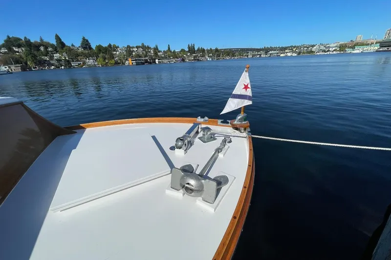Slide: The Image of 1939 Richardson 26 Little Giant boat on calm lake with flag and scenic shoreline. - 35