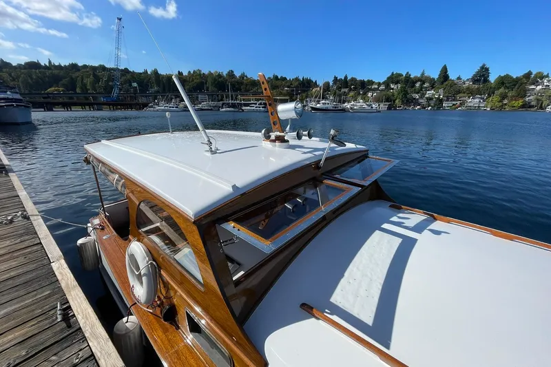 Slide: The Image of 1939 Richardson 26 Little Giant boat docked on a sunny day by the lake. - 37