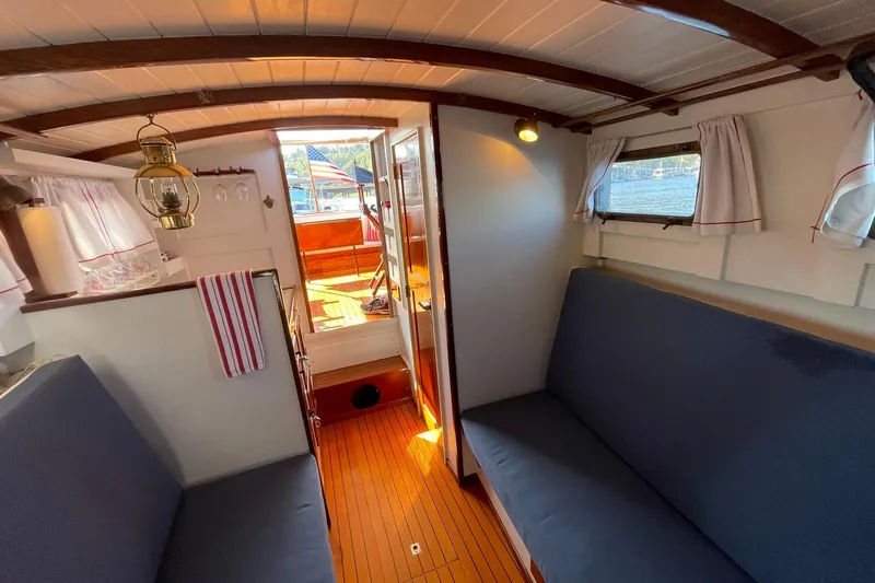 Slide: The Image of Interior of 1939 Richardson 26 Little Giant boat with wooden floors and cozy seating. - 4