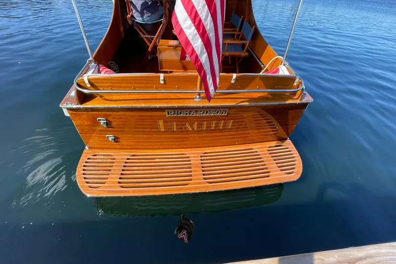 Slide: The Image of Vintage 1939 Richardson 26 Little Giant boat with American flag on calm water. - 42