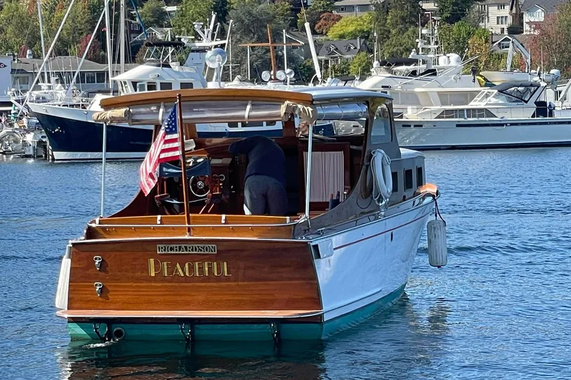 Slide: The Image of Classic 1939 Richardson 26 Little Giant boat named "Peaceful" on a serene marina. - 43