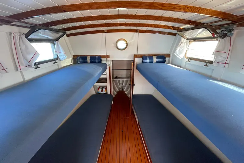 Slide: The Image of Interior of 1939 Richardson 26 Little Giant boat with blue bunk beds and wooden ceiling. - 5