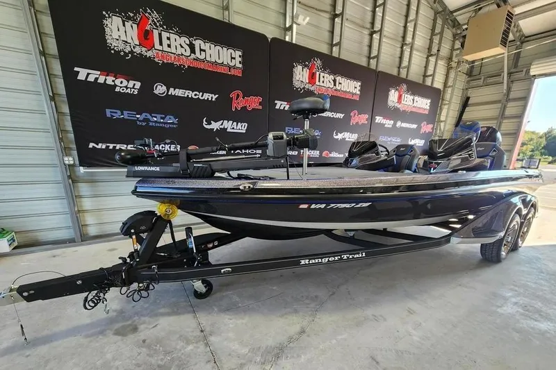Slide: The Image of 2024 Ranger Z520R Ranger Cup Equipped boat in showroom with promotional banners. - 2