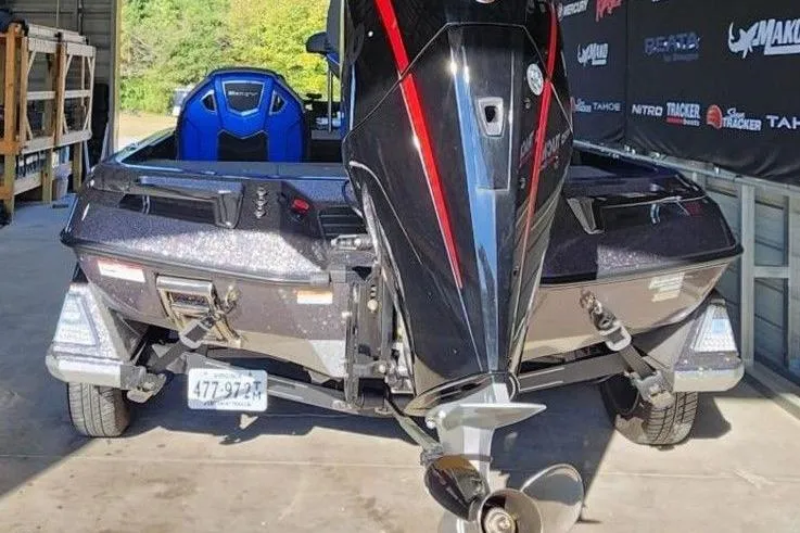 Slide: The Image of 2024 Ranger Z520R Ranger Cup Equipped boat in a garage, rear view with motor. - 3