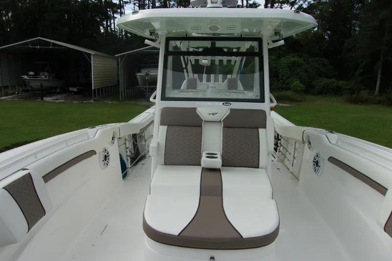 Slide: The Image of 2025 Tidewater 320 CC Adventure boat interior with cushioned seating and modern design. - 11
