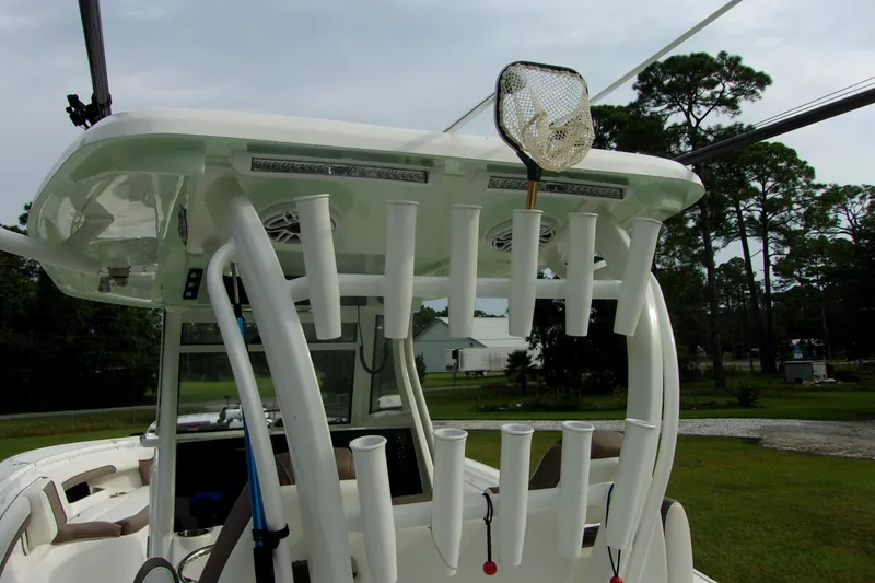 Slide: The Image of 2025 Tidewater 320 CC Adventure boat with rod holders and fishing net. - 30