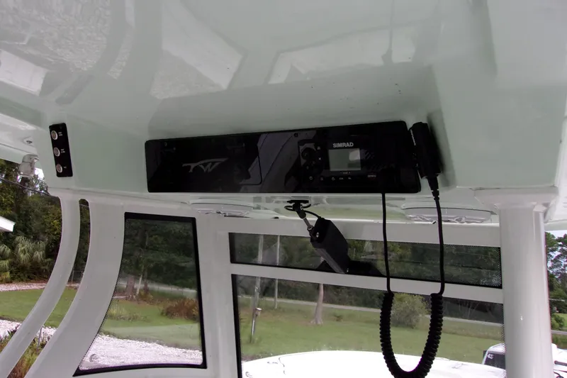 Slide: The Image of 2025 Tidewater 320 CC Adventure boat interior with Simrad electronics and overhead console. - 34