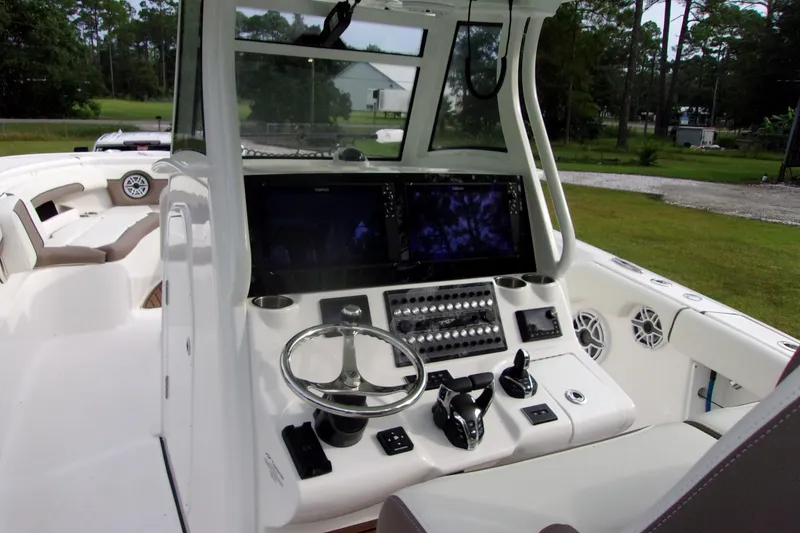Slide: The Image of 2025 Tidewater 320 CC Adventure boat cockpit with advanced controls and navigation screens. - 50