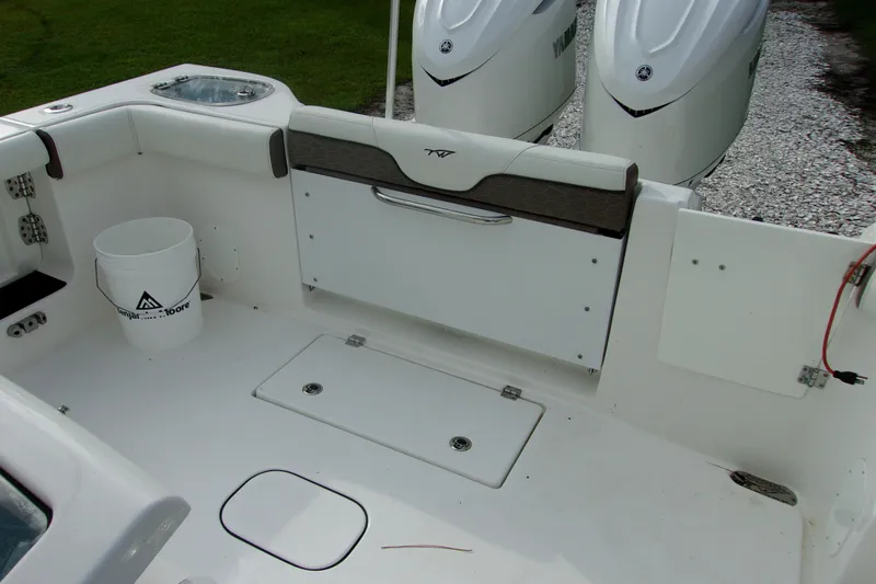 Slide: The Image of 2025 Tidewater 320 CC Adventure boat interior with seating and storage compartments. - 53