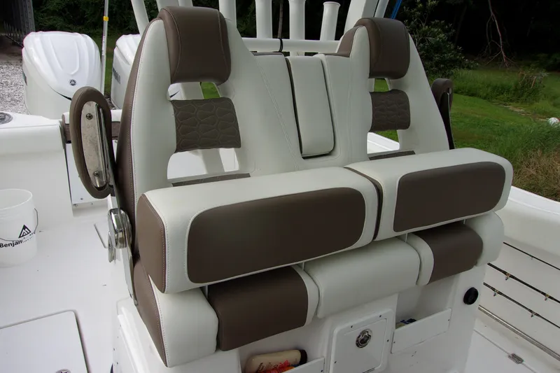 Slide: The Image of 2025 Tidewater 320 CC Adventure boat seats with brown and white upholstery. - 58