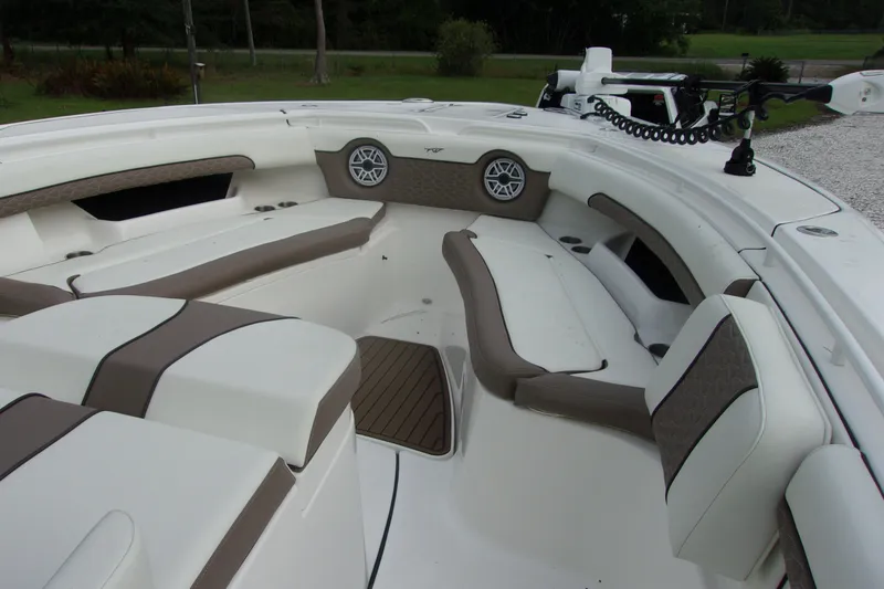 Slide: The Image of 2025 Tidewater 320 CC Adventure boat interior with cushioned seating and speakers. - 59