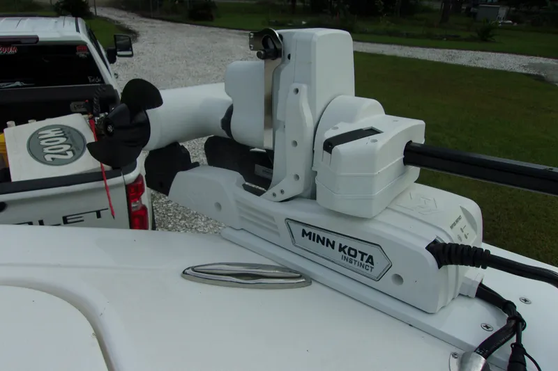 Slide: The Image of Minn Kota Instinct motor on 2025 Tidewater 320 CC Adventure boat, parked near a Chevrolet truck. - 60