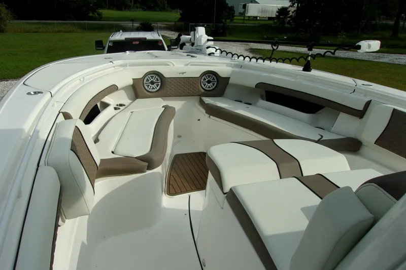 Slide: The Image of 2025 Tidewater 320 CC Adventure boat interior with cushioned seating and speakers. - 63