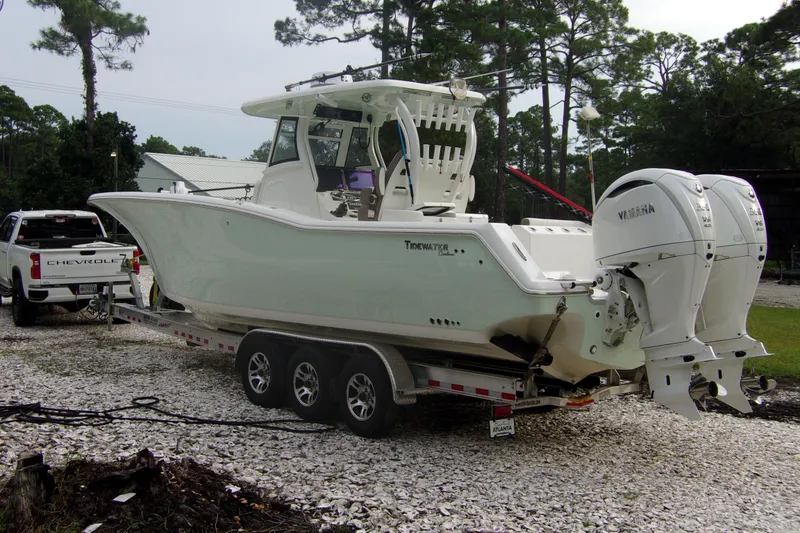 Slide: The Image of 2025 Tidewater 320 CC Adventure boat on trailer with dual Yamaha engines. - 68