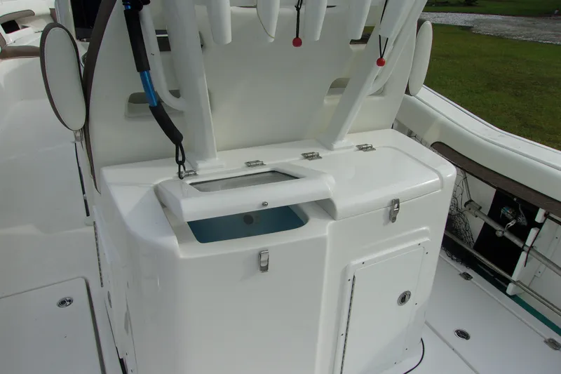 Slide: The Image of 2025 Tidewater 320 CC Adventure boat interior with storage compartments and fishing rod holders. - 7