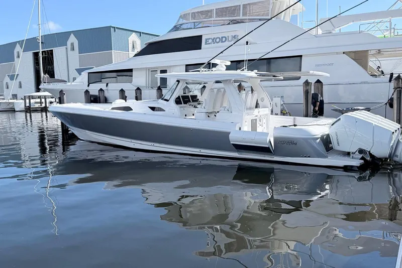 The Image of 2025 Intrepid 51 Panacea boat docked at marina, featuring sleek design and powerful engines. - 0