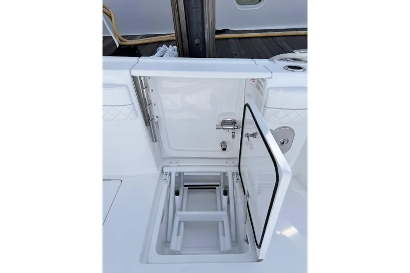 Slide: The Image of 2025 Intrepid 51 Panacea boat hatch with open storage compartment. - 2