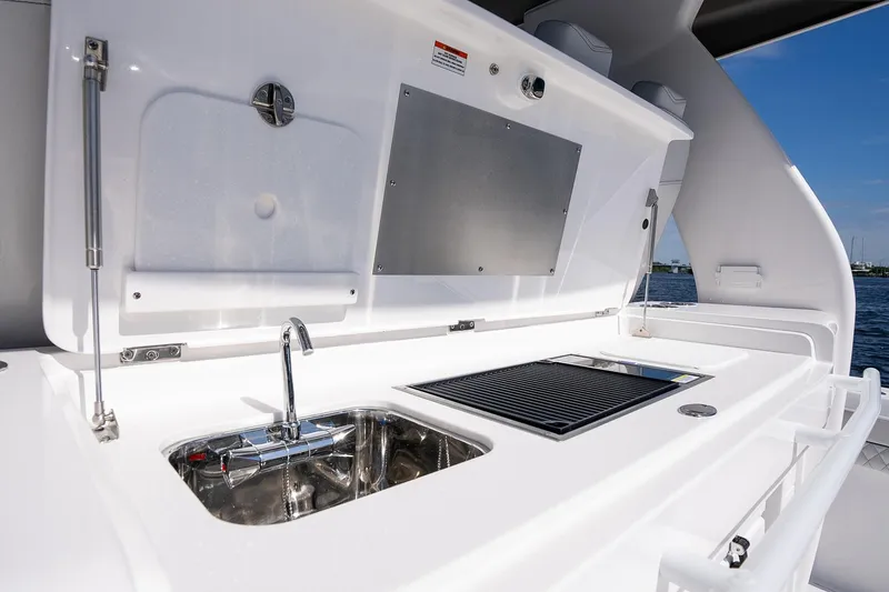 Slide: The Image of Manufacturer Provided Image: Intrepid 51 Panacea 2025 yacht outdoor kitchen with sink and grill. - 23