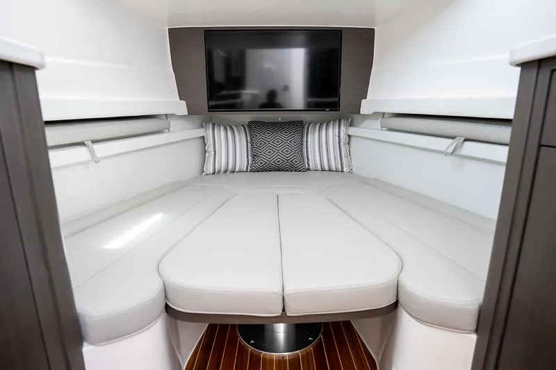 Slide: The Image of Manufacturer Provided Image: Luxurious cabin interior of 2025 Intrepid 51 Panacea with modern bedding and TV. - 27