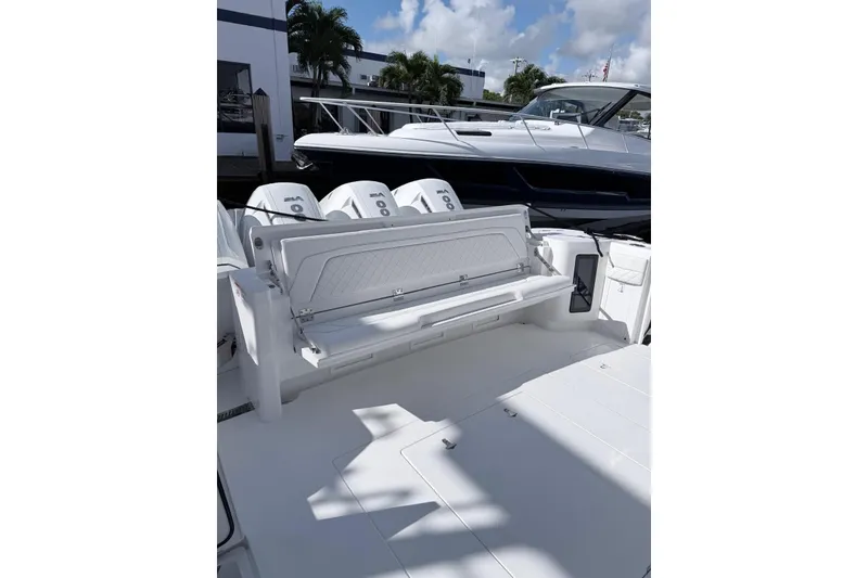Slide: The Image of 2025 Intrepid 51 Panacea boat with triple outboard engines, docked under a sunny sky. - 3