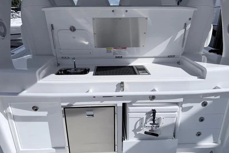 Slide: The Image of Intrepid 51 Panacea 2025 yacht kitchen area with sink, grill, and storage compartments. - 4