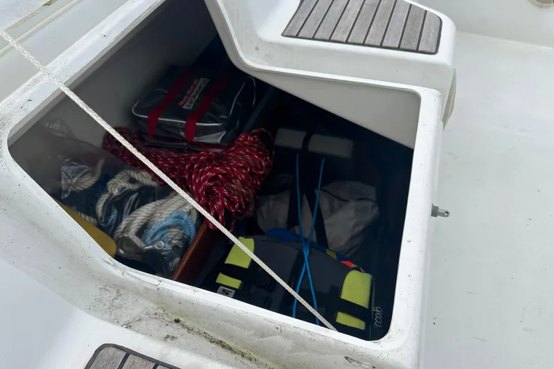 Slide: The Image of Open storage compartment on 2011 Beneteau Oceanis 37 sailboat with ropes and gear. - 18