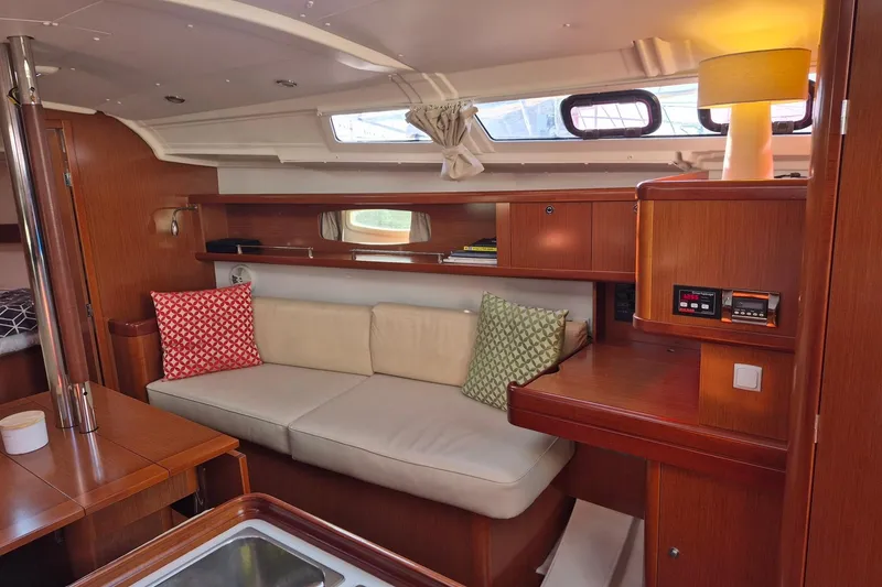 Slide: The Image of Interior of 2011 Beneteau Oceanis 37 yacht with cozy seating and wooden cabinetry. - 21