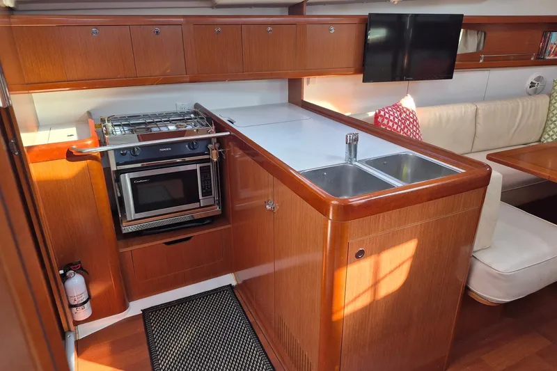 Slide: The Image of Interior of 2011 Beneteau Oceanis 37 yacht with kitchen and seating area. - 22