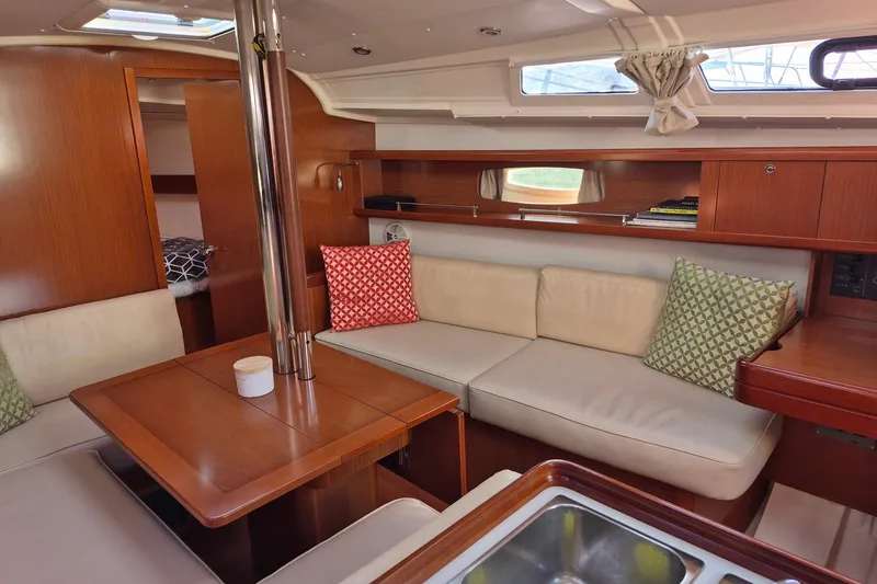 Slide: The Image of Interior of 2011 Beneteau Oceanis 37 yacht with cozy seating and wooden finishes. - 26