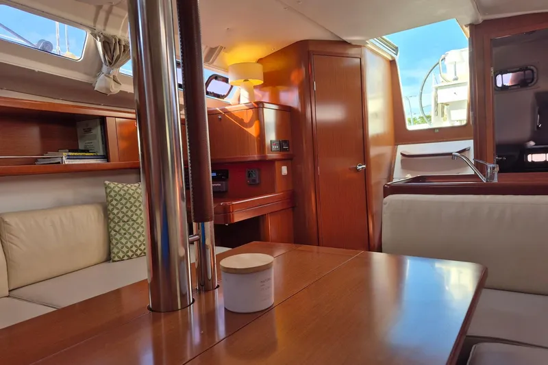 Slide: The Image of Interior of 2011 Beneteau Oceanis 37 yacht with wood finish and cozy seating area. - 28