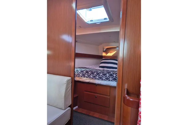Slide: The Image of Interior cabin of 2011 Beneteau Oceanis 37 sailboat with cozy bed and wooden finish. - 29