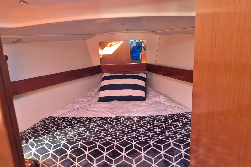 Slide: The Image of Cozy cabin interior of 2011 Beneteau Oceanis 37 sailboat with striped pillow. - 30