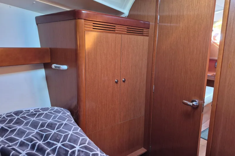 Slide: The Image of Interior cabin of 2011 Beneteau Oceanis 37 yacht with wooden closet and bed. - 32